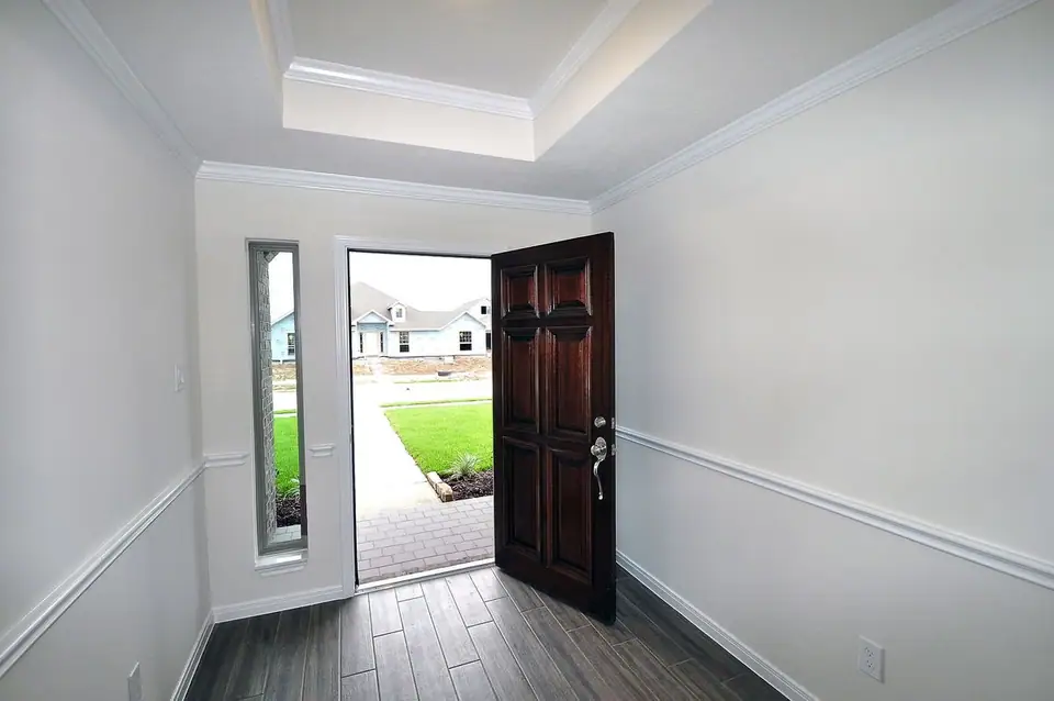 Entry foyer with an open wood front door at 2238 Ensenada Drive, League City, Texas