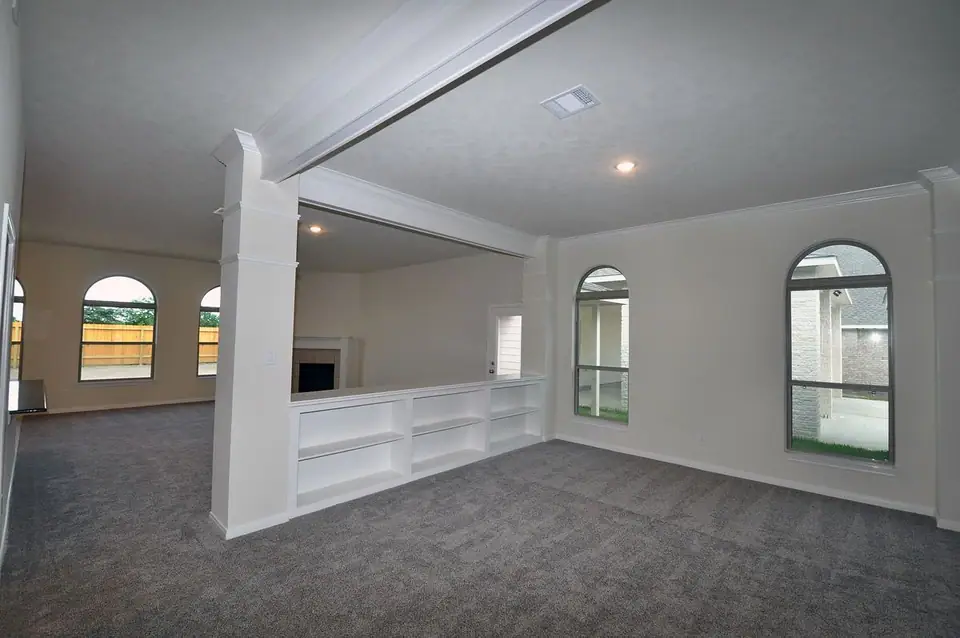 Open living area and kitchen pass-through at 3821 Verde River Road, League City, Texas