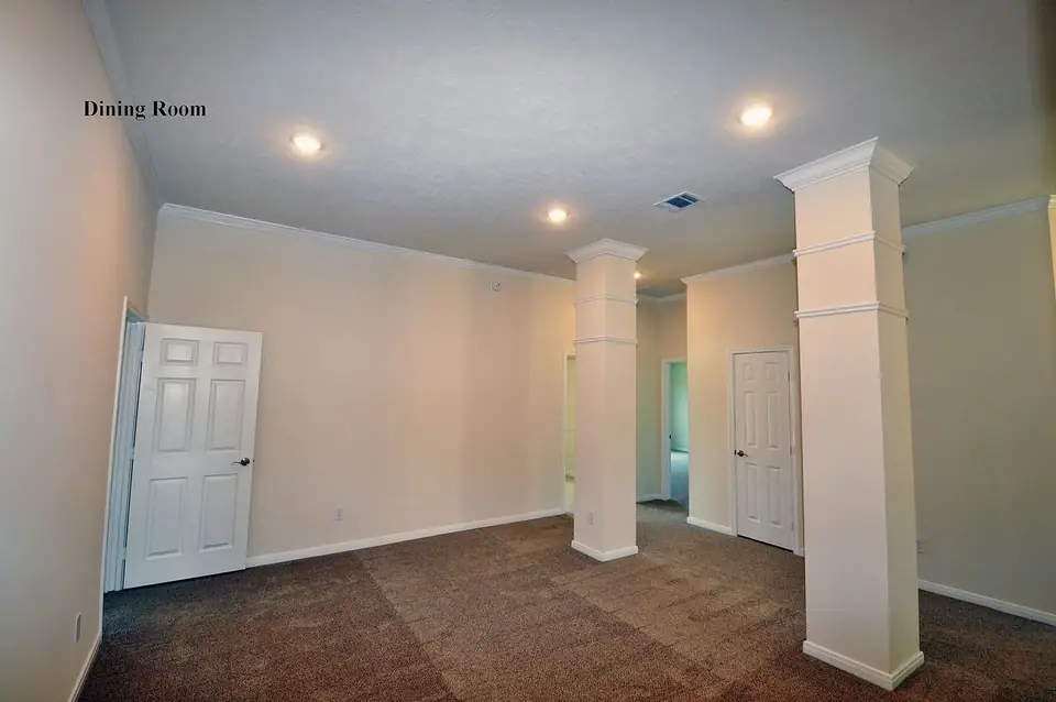 Dining area with wood-look flooring and a tray ceiling at 2210 Fortuna Drive, League City, Texas