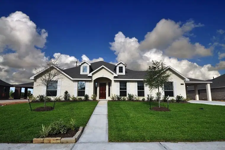 Front exterior with arched entrance and landscaped walkway at 3821 Verde River Road, League City, Texas