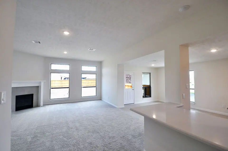 Living room with a fireplace and kitchen pass-through at 2206 Fortuna Drive, League City, Texas