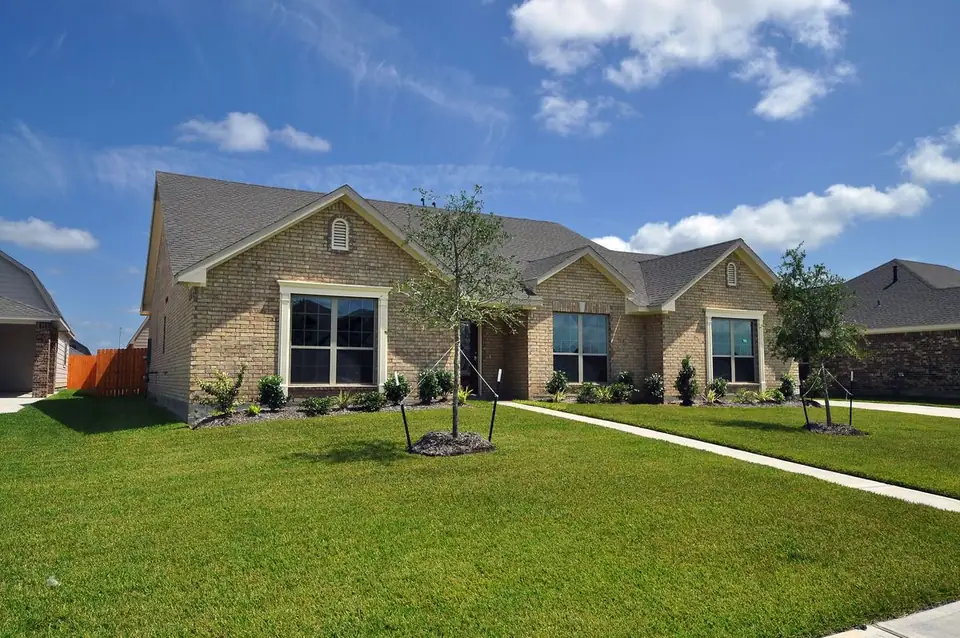 Angled front view with arched entry at 2210 Fortuna Drive, League City, Texas