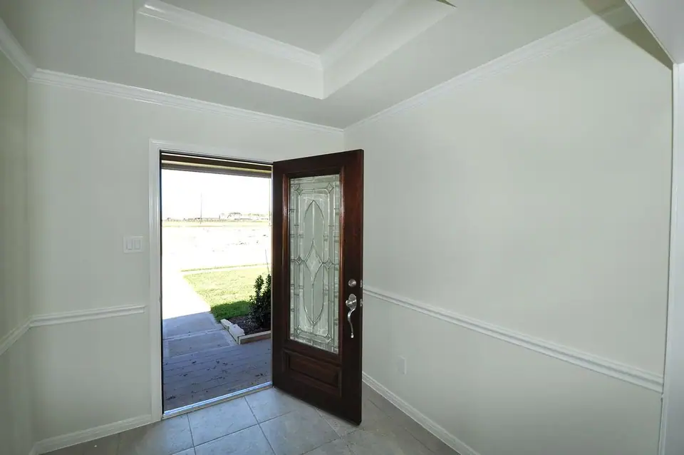 Entry foyer with a tray ceiling and open front door at 2207 Dorado Street, League City, Texas