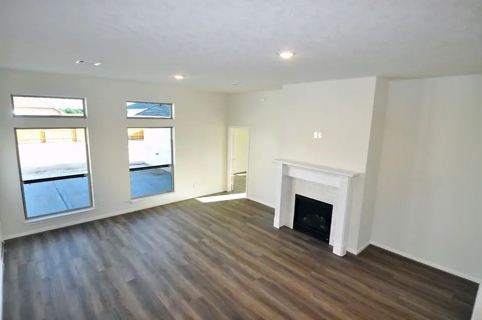 Living area with wood-look flooring and large windows at 2231 Ensenada Drive, League City, Texas