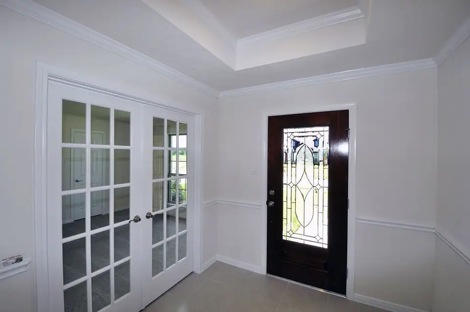 Entry foyer beside a room with glass doors at 2210 Fortuna Drive, League City, Texas
