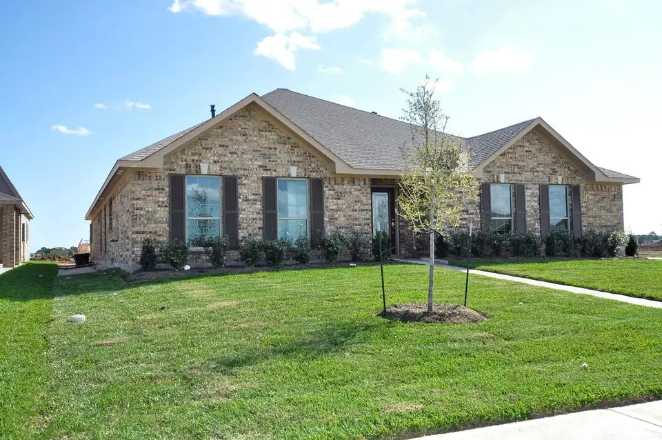 Angled front exterior with mature lawn at 2207 Dorado Street, League City, Texas