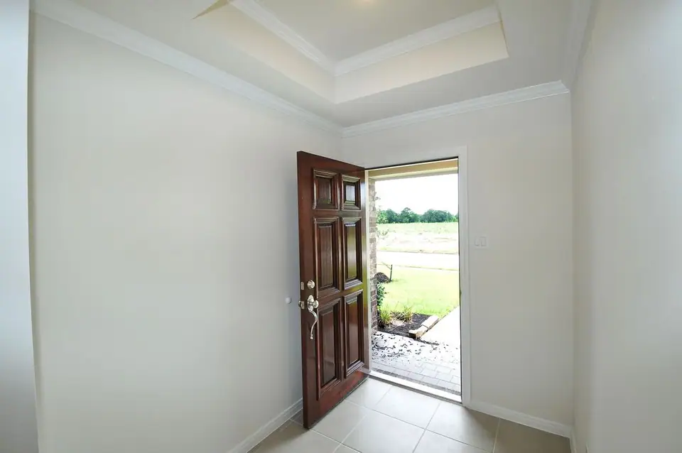 Entry foyer with an open wood front door at 2206 Fortuna Drive, League City, Texas