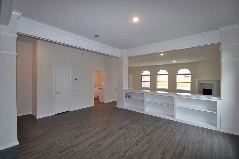 Open living area with columns and kitchen pass-through at 2238 Ensenada Drive, League City, Texas