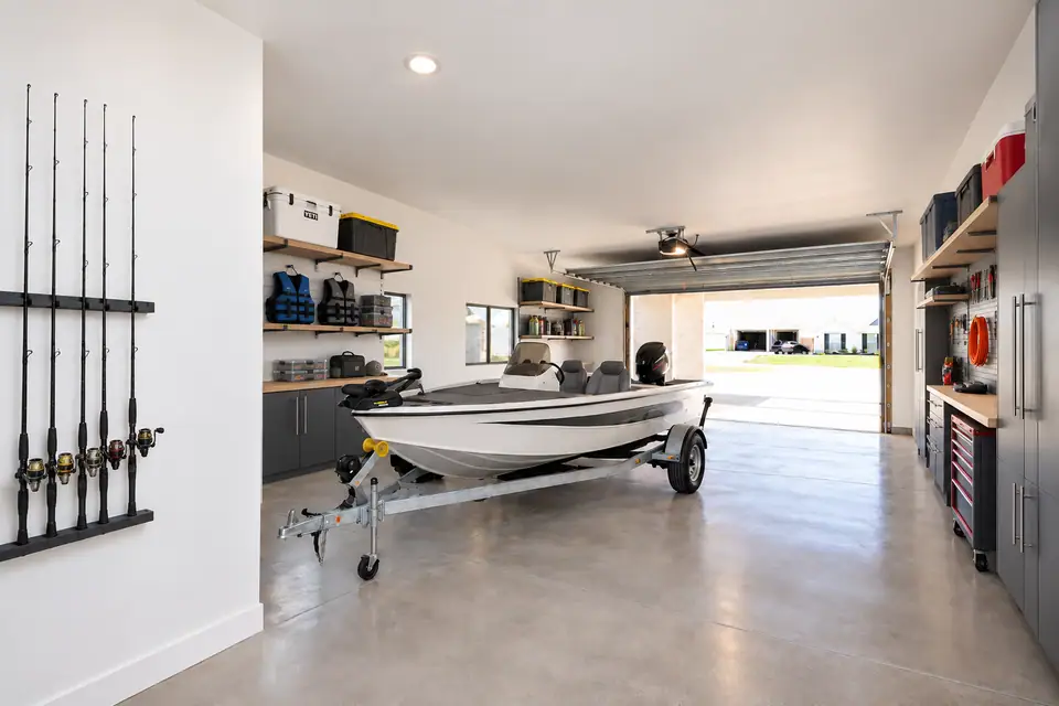 Fishing boat and organized storage inside a spacious garage