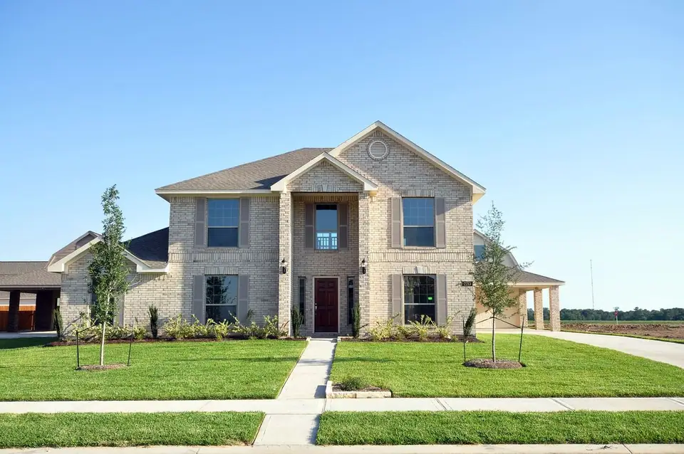 Two-story front exterior and landscaped walkway at 2213 Ensenada Drive, League City, Texas