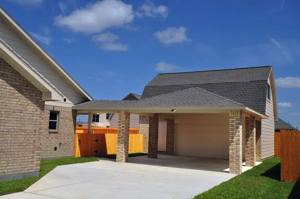 Garage and covered driveway beside the home at 2210 Fortuna Drive, League City, Texas