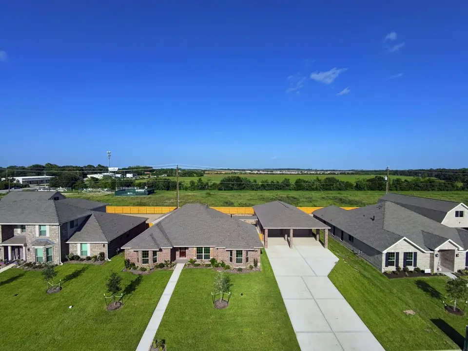 Aerial view of the home and neighboring construction at 3805 Verde River Road, League City, Texas
