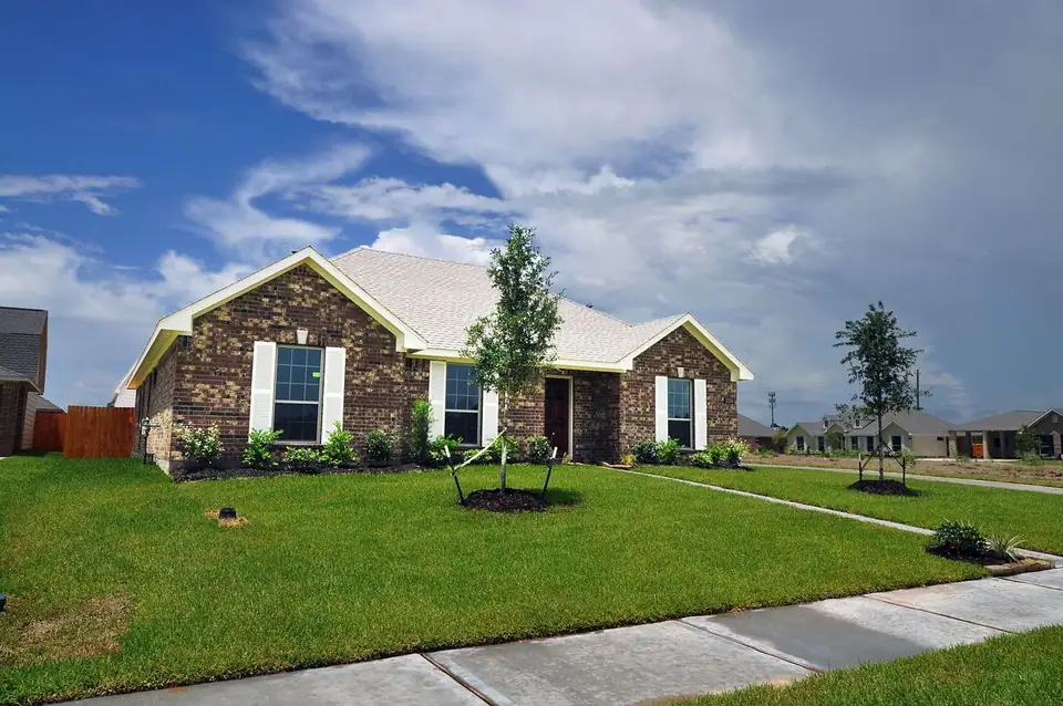 Angled front view of the brick home and lawn at 2206 Fortuna Drive, League City, Texas