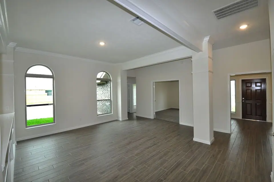 Open living and dining area with arched windows at 2238 Ensenada Drive, League City, Texas